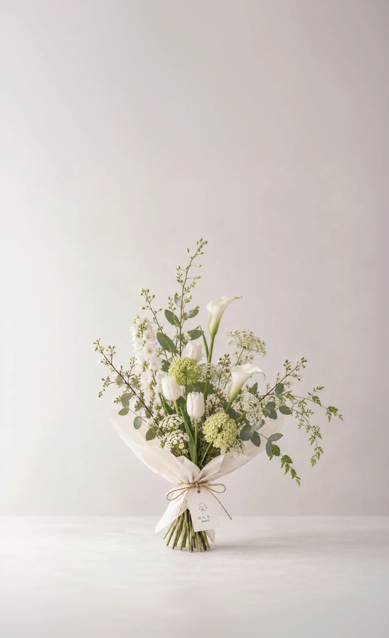 Fresh green and white flowers arranged in a natural, open bouquet