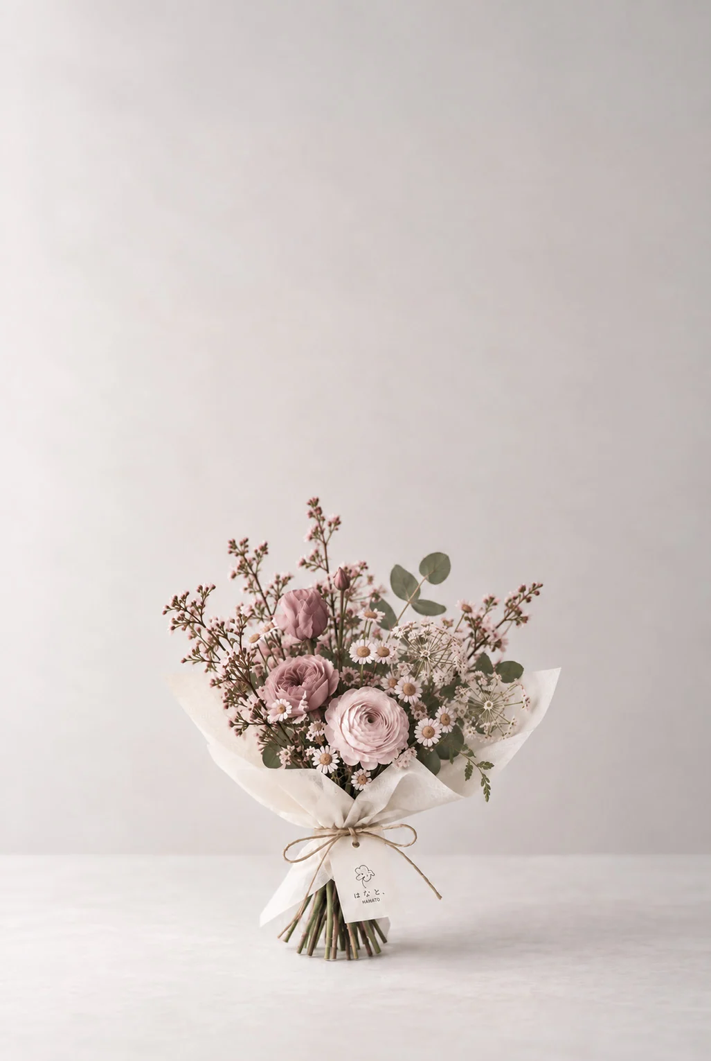 A softly wrapped pink bouquet with fine branching stems